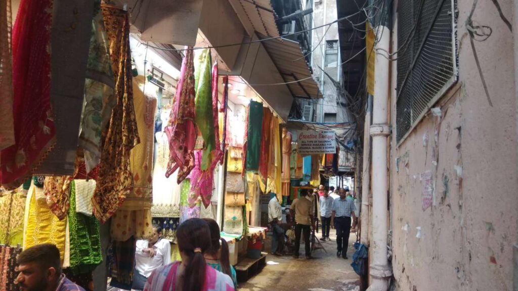 Chandni chowk Market  Street with shops of colorful clothes. 