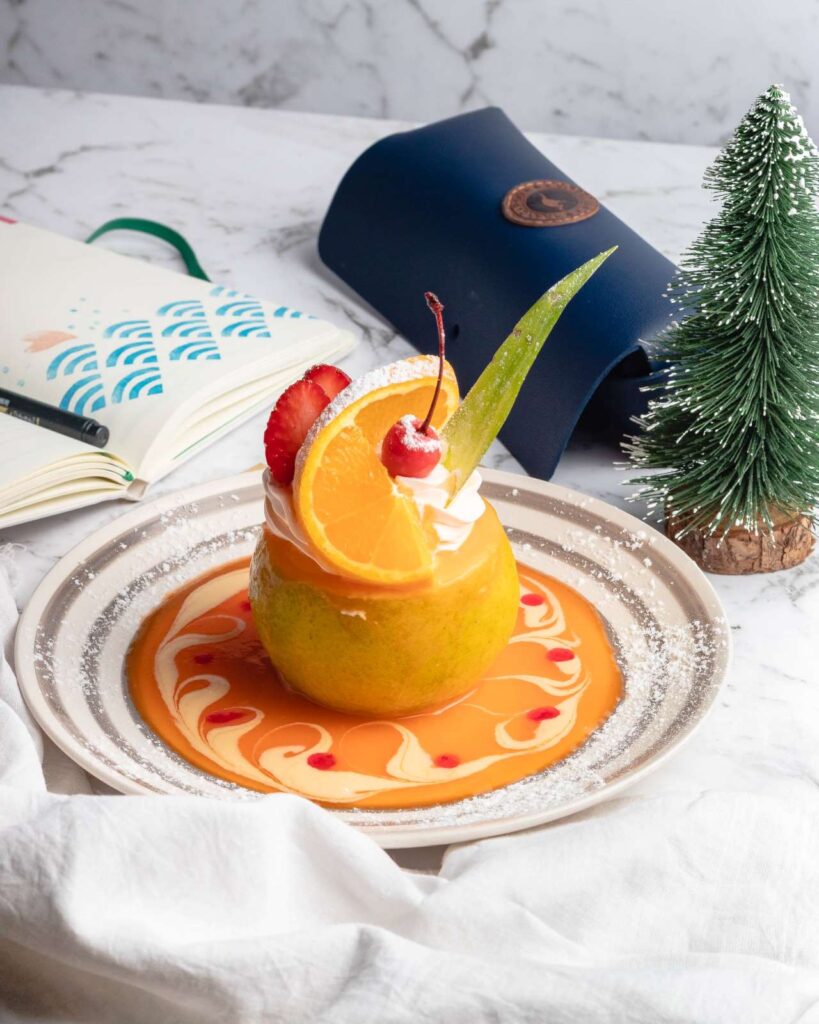 Mango Ice cream with strawberry, orange and cream.