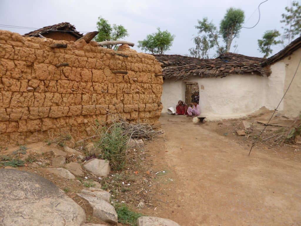 Two women siting outside of their house at Khajuraho Village.