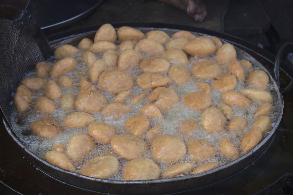 Kachori frying in the big iron pot.