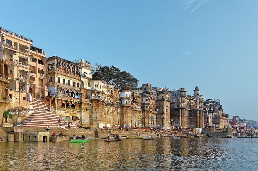 Varansi Ghat with the small boats and people sitting in the boats.